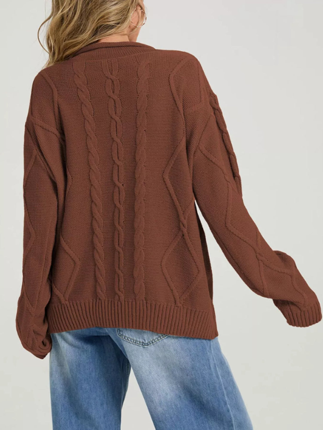 Back view of the rust brown cable knit sweater with long sleeves
