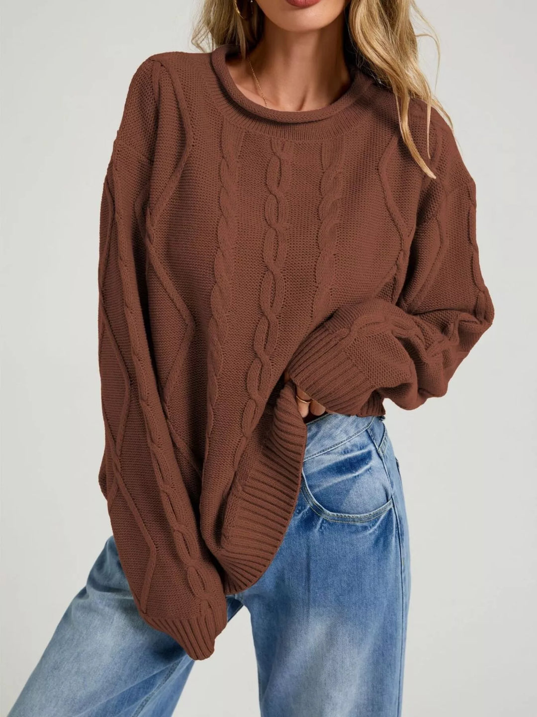 Women's rust brown oversized sweater with cable knit and rolled neck, front view