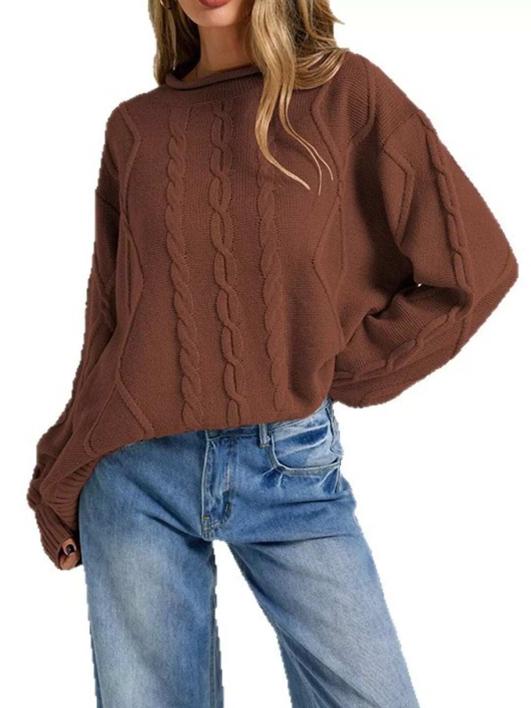 Rust brown oversized cable knit sweater, side pose with hand in jeans pocket