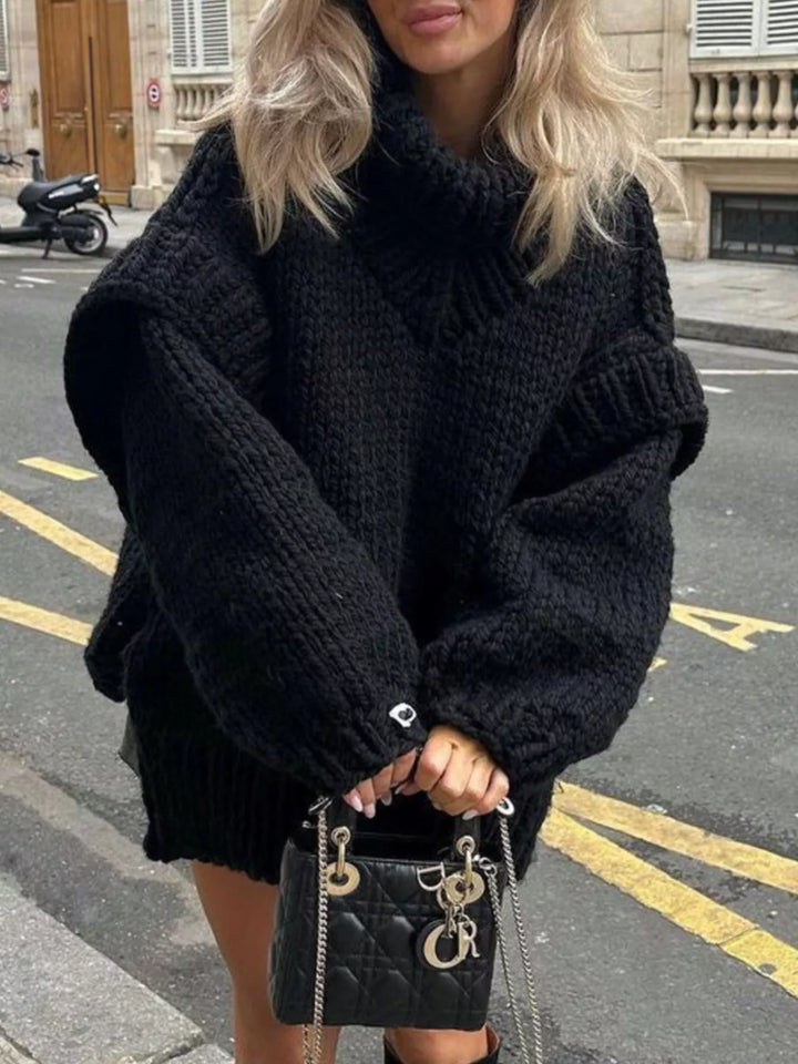 Black chunky turtleneck sweater styled with a small handbag on the street