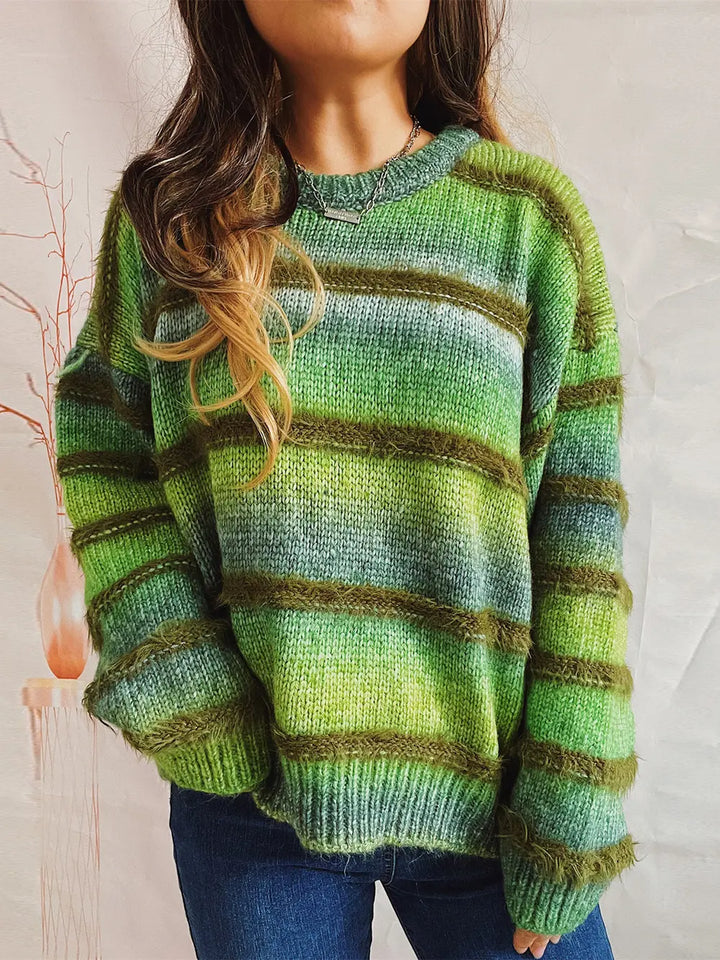 Green fuzzy striped sweater worn with jeans, front view