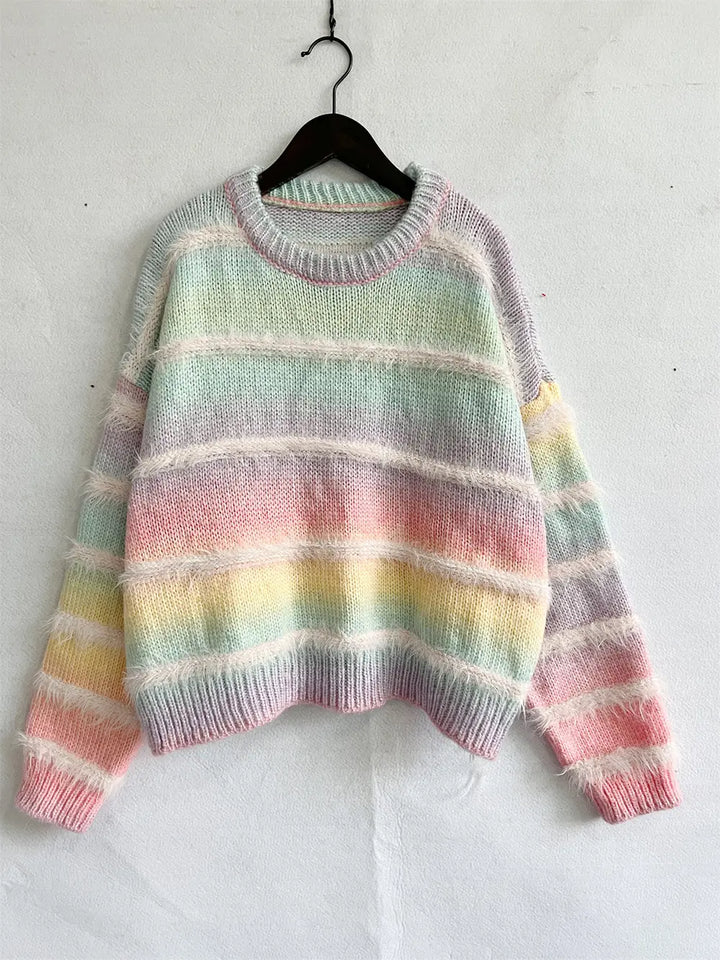Pastel multicolor fuzzy sweater hanging on a hanger, front view