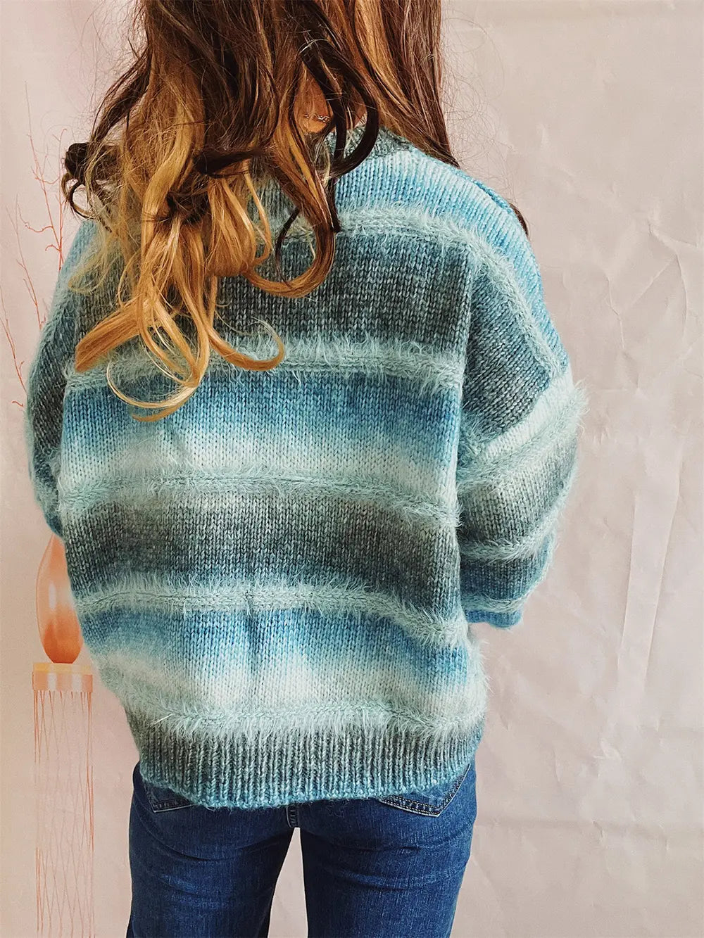 Back view of the teal blue fuzzy striped sweater