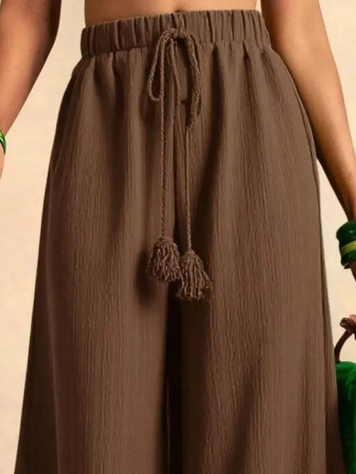 Close-up of the brown palazzo pants waist with the knotted tassel drawstring