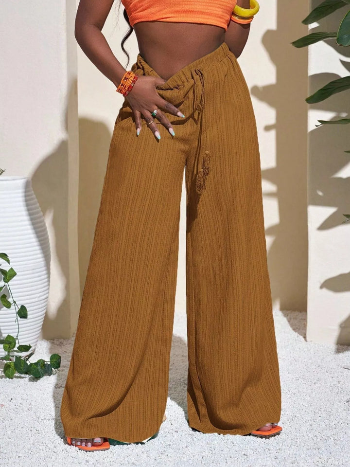 Mustard palazzo pants with a drawstring waist, close view of the high waist