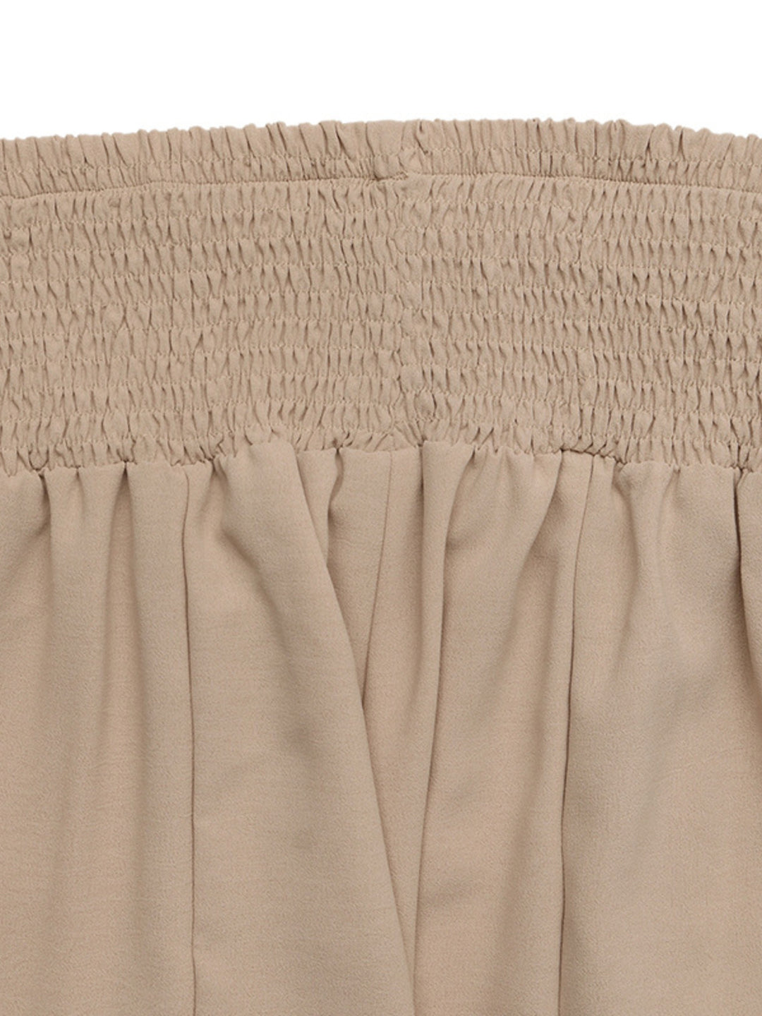 Close-up of the tan smocked waistband gathered ruching