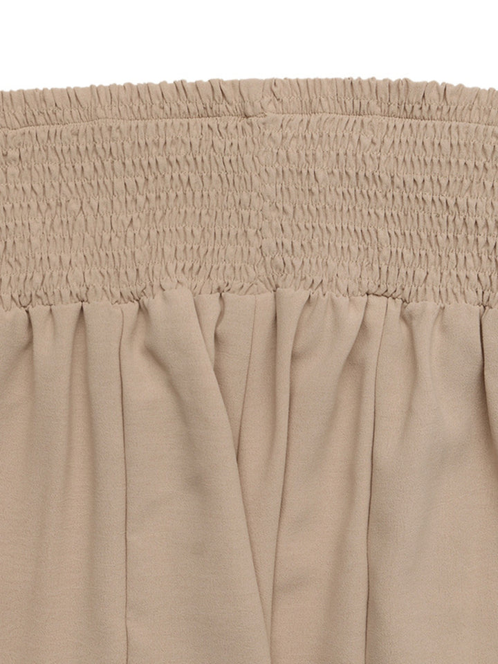 Close-up of the tan smocked waistband gathered ruching
