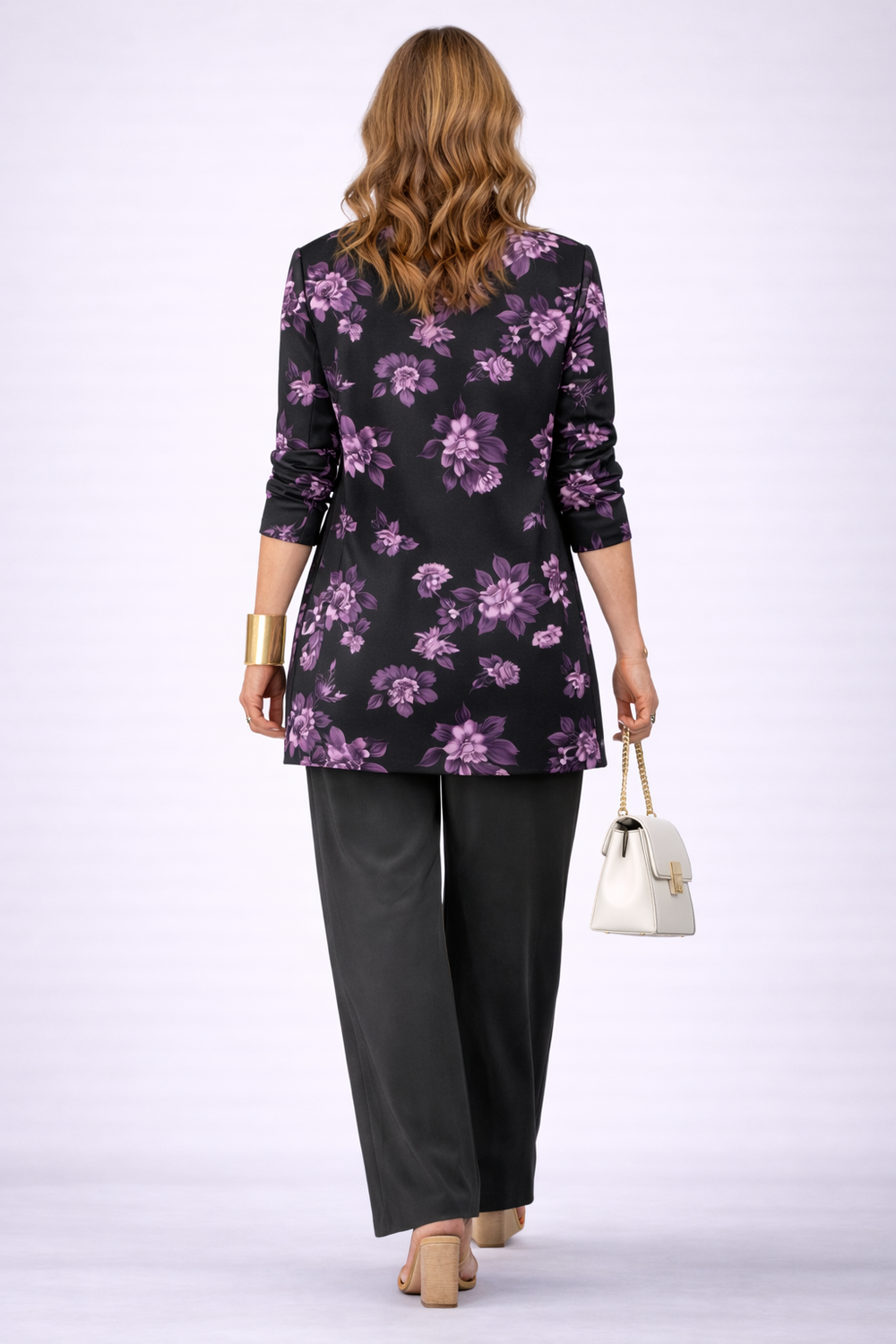 Back view of the purple rose print cardigan over black straight leg pants