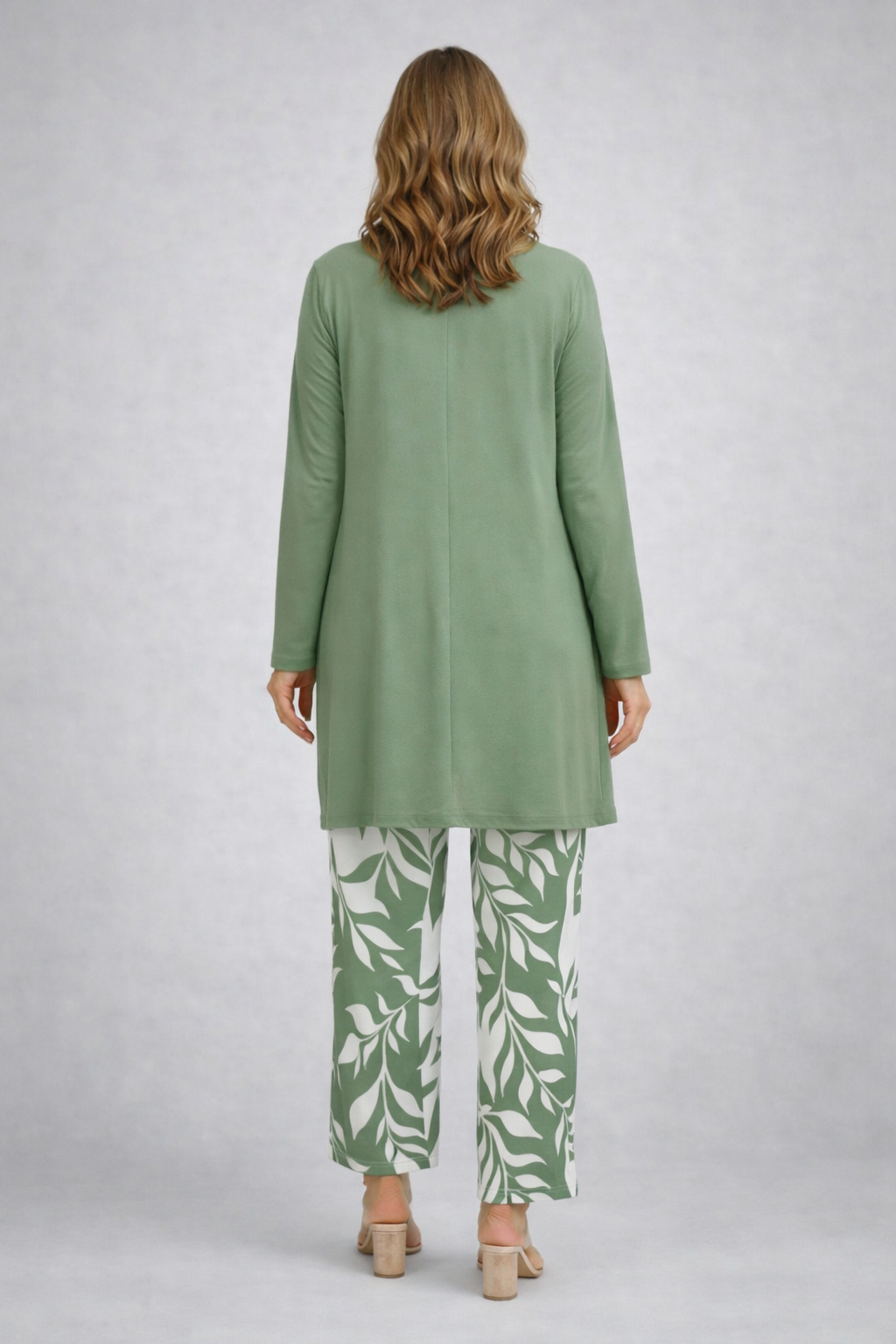 Back view of the sage cardigan with a center seam over white and sage print pants