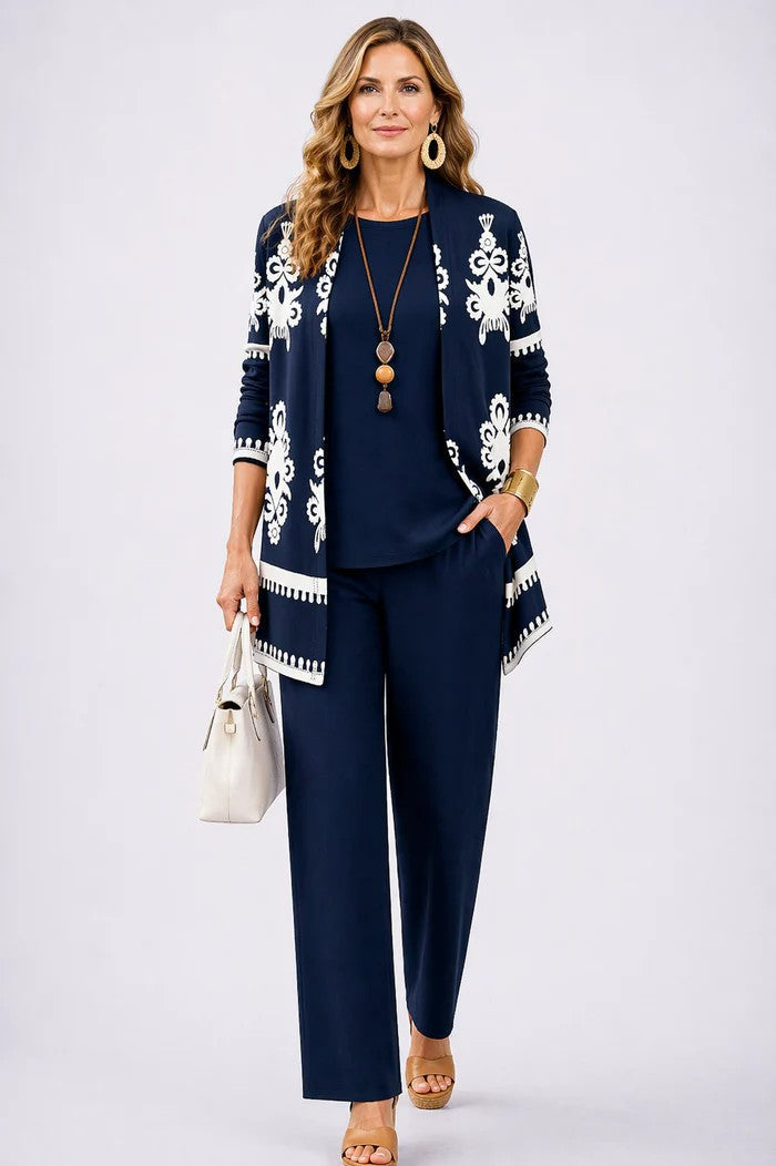 Navy cardigan with white baroque border print over navy top and pants