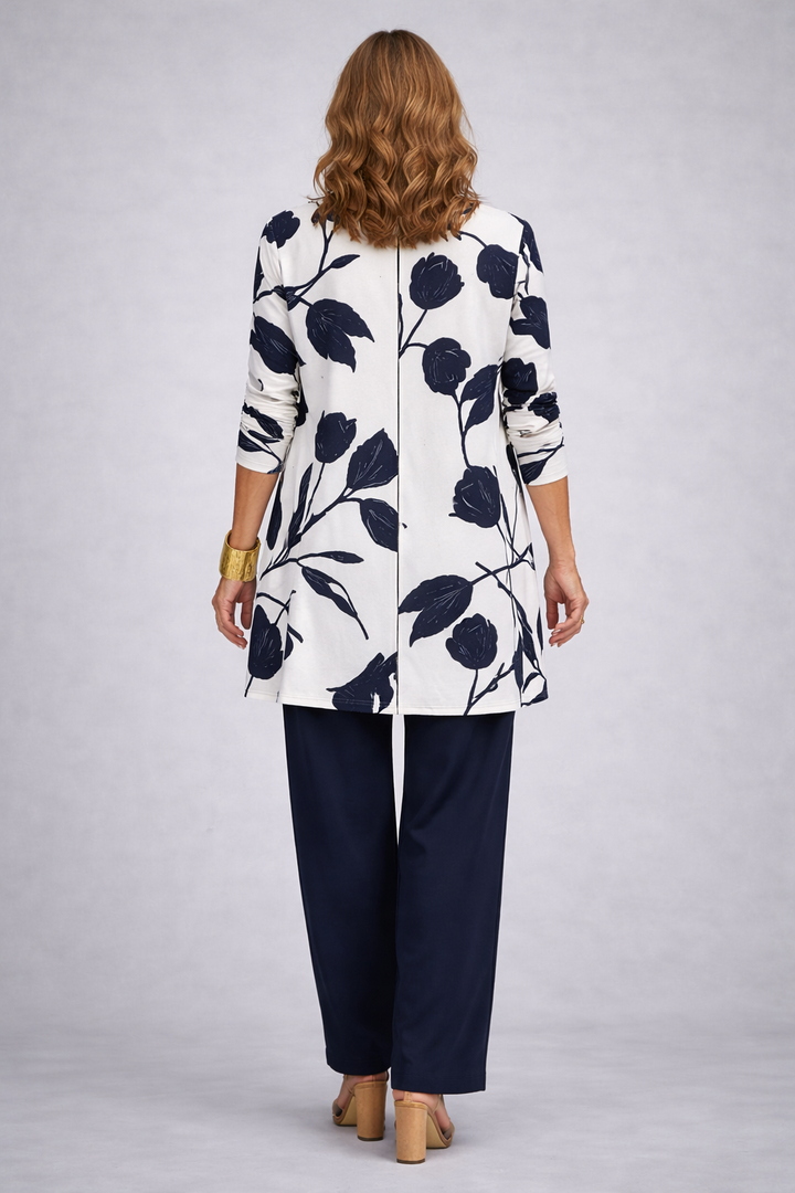 Back view of the tulip print cardigan with its center seam over navy pants