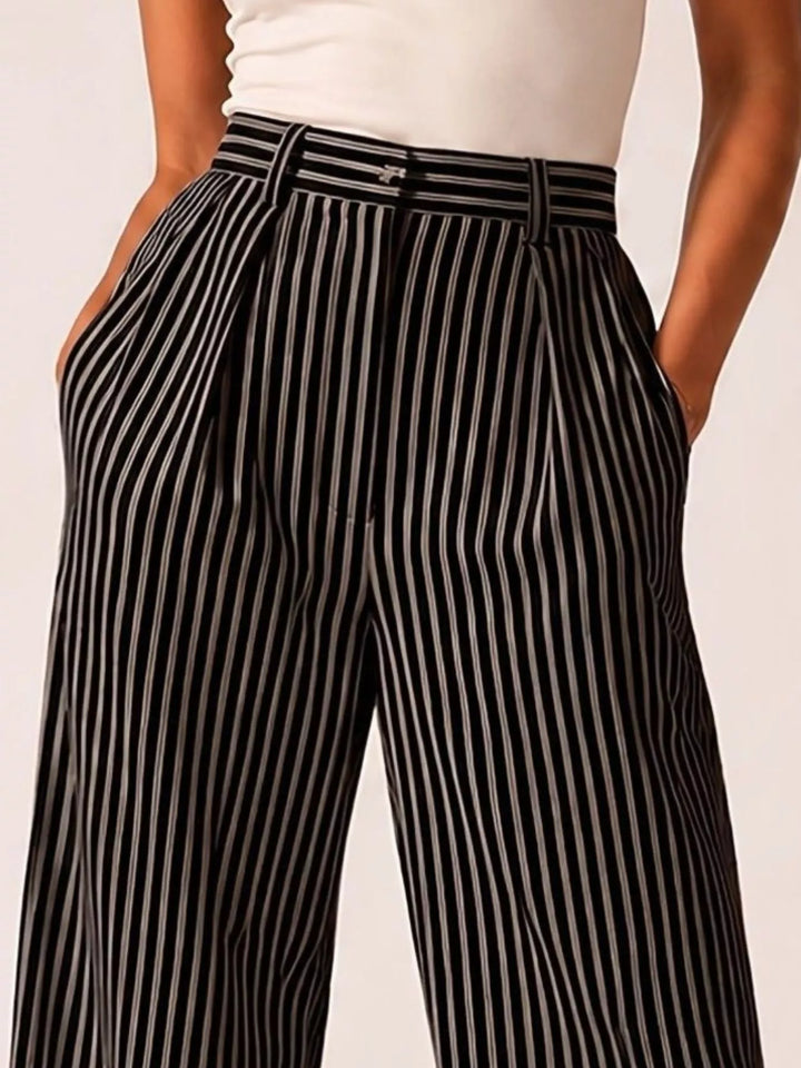 Black pinstripe wide leg pants close-up of the pleats and waistband