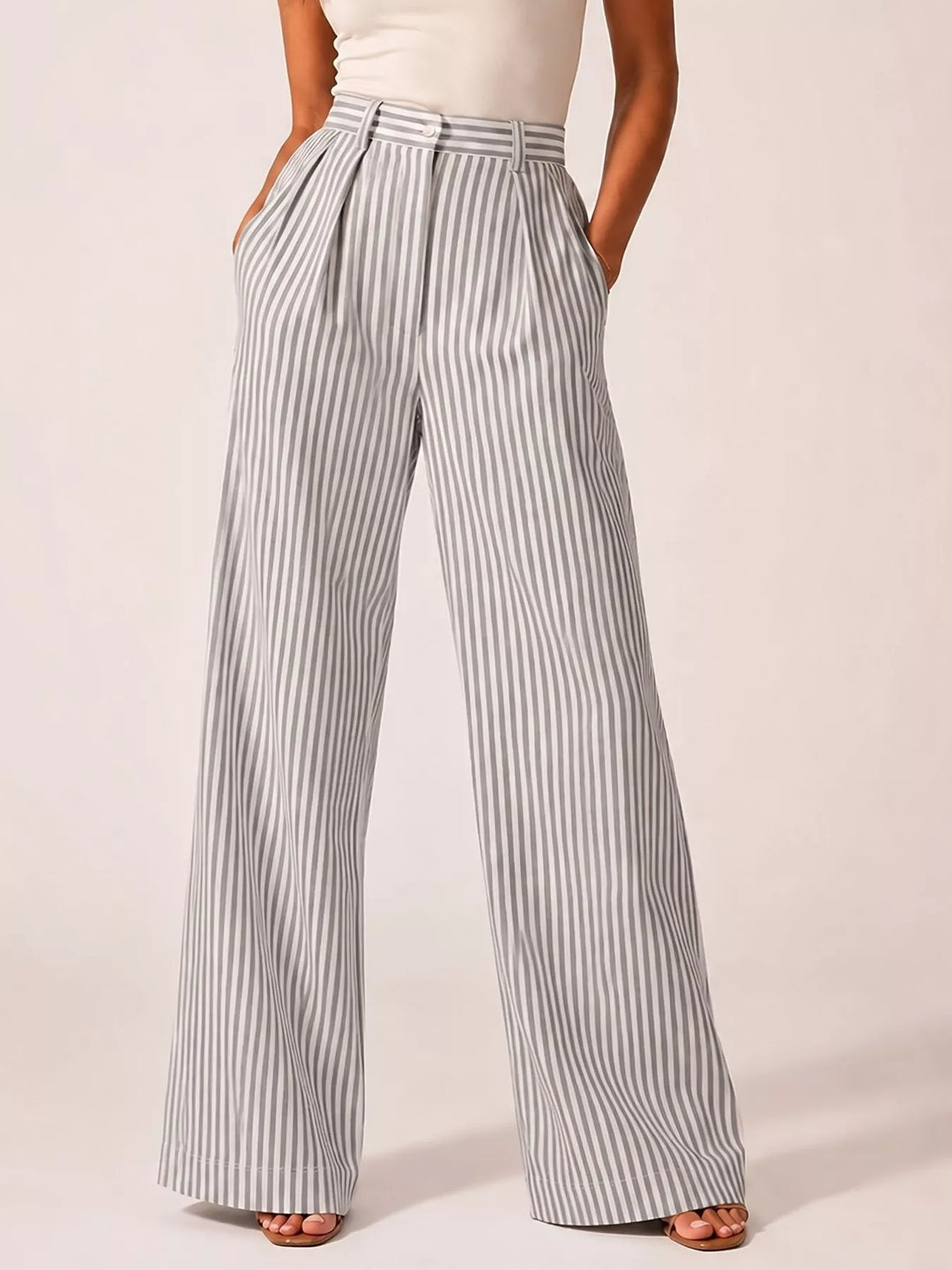Gray pinstripe pleated wide leg pants, standing front view with hands in pockets