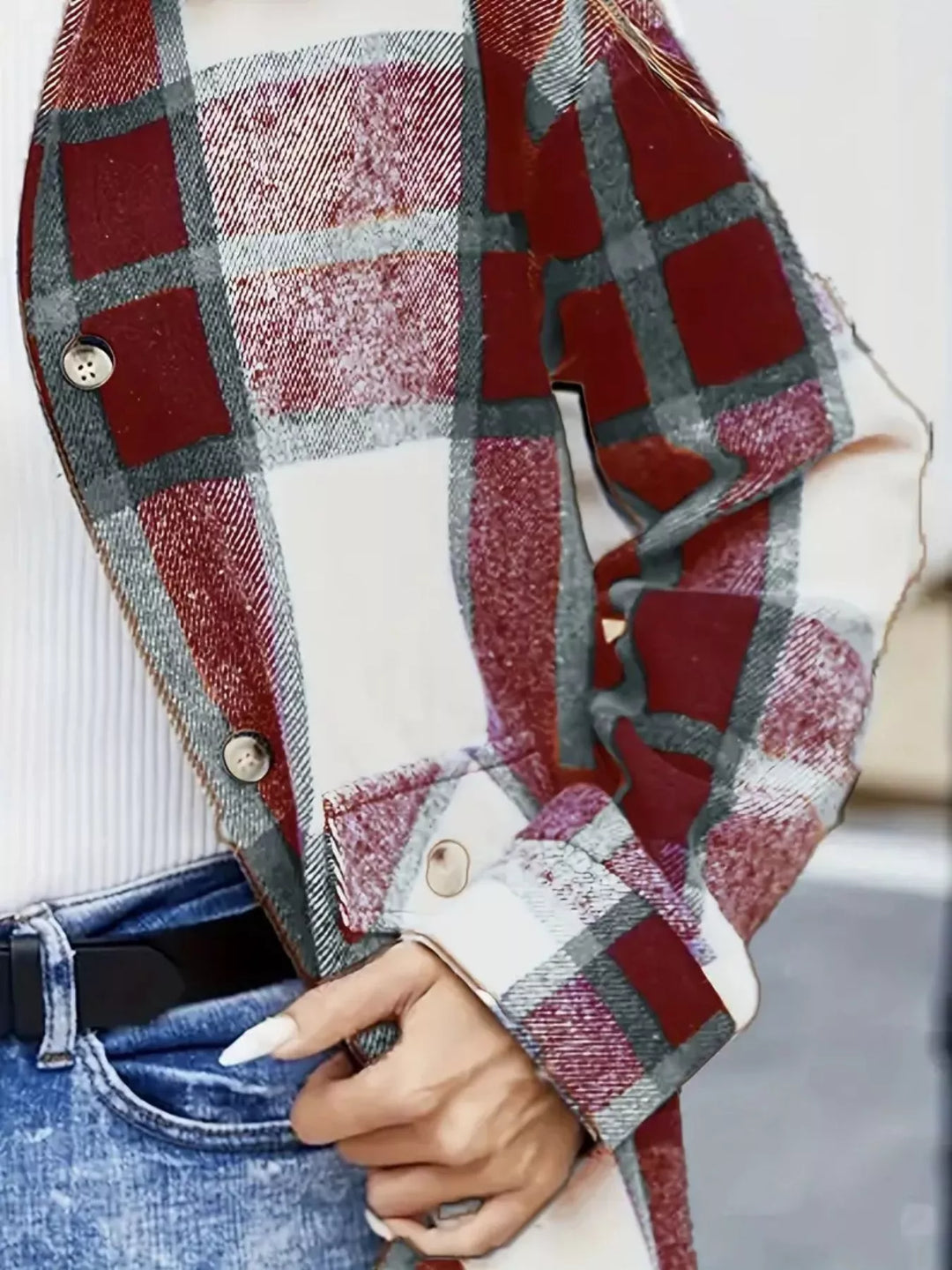 Close-up of the burgundy plaid shacket button cuff and chest pocket