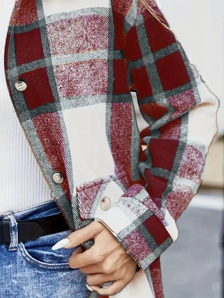 Close-up of the burgundy plaid shacket button cuff and chest pocket