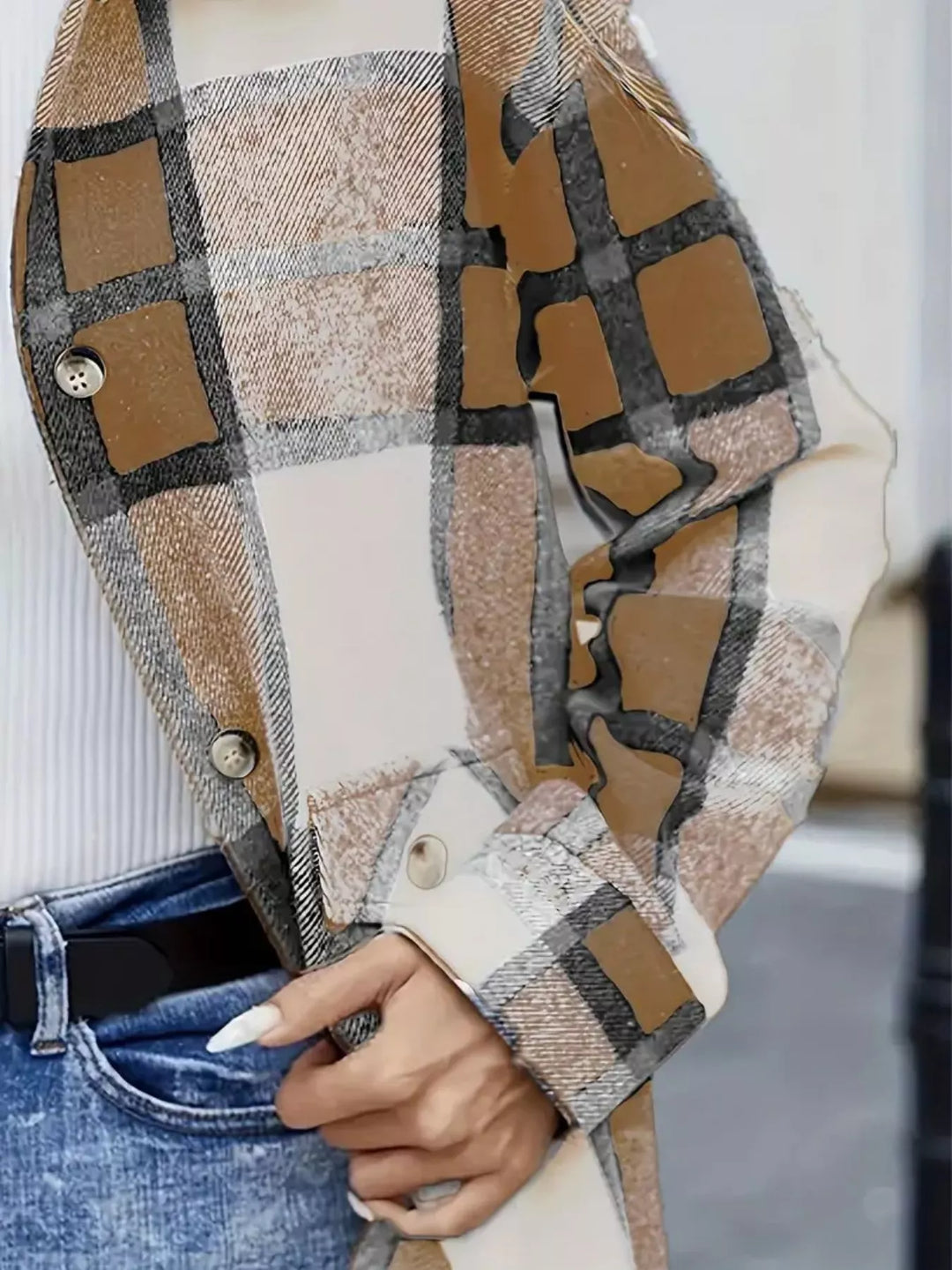Close-up of the camel plaid shacket buttons, pocket and cuff detail