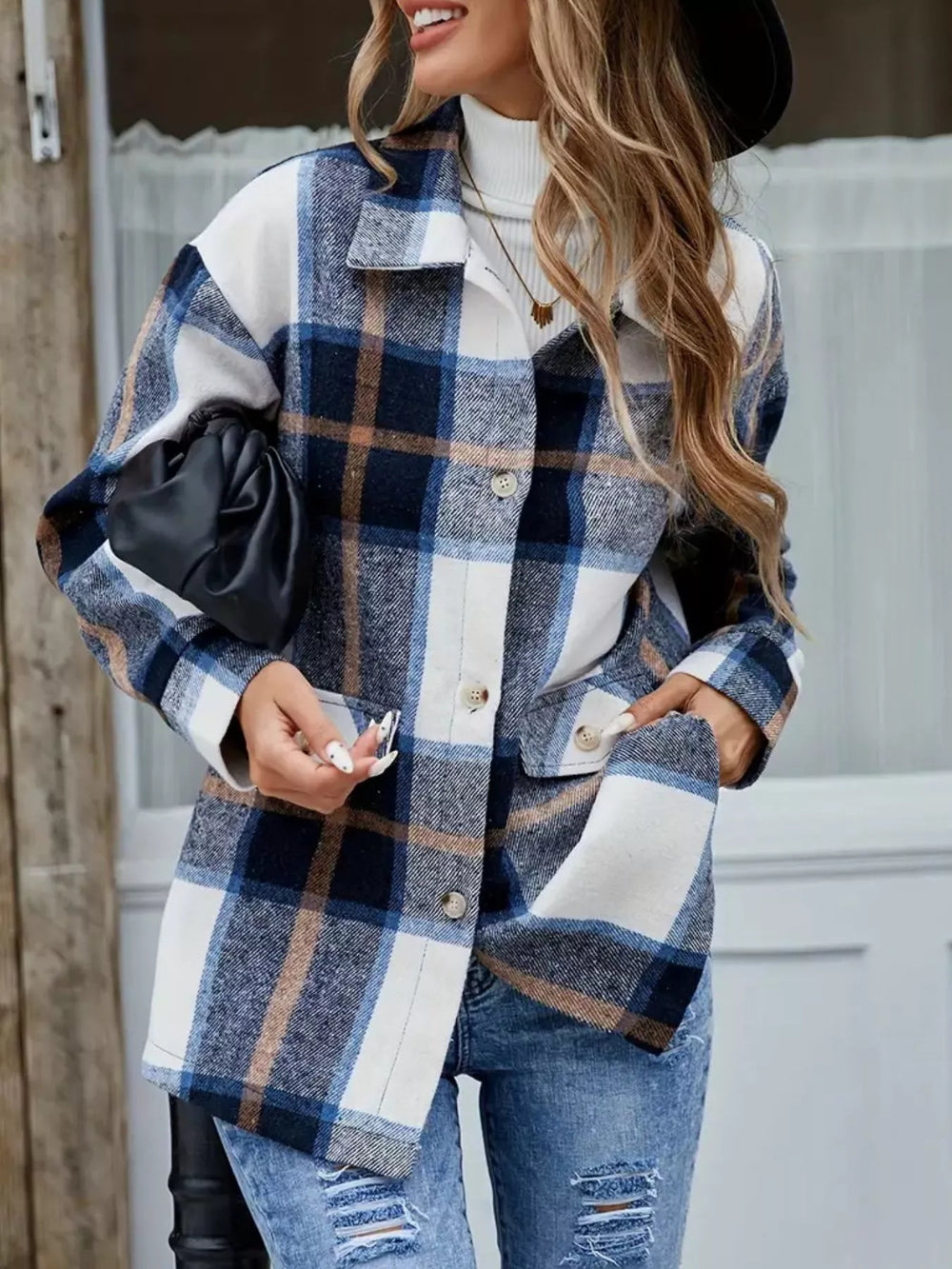 Navy plaid shacket worn open with a black bag and ripped jeans