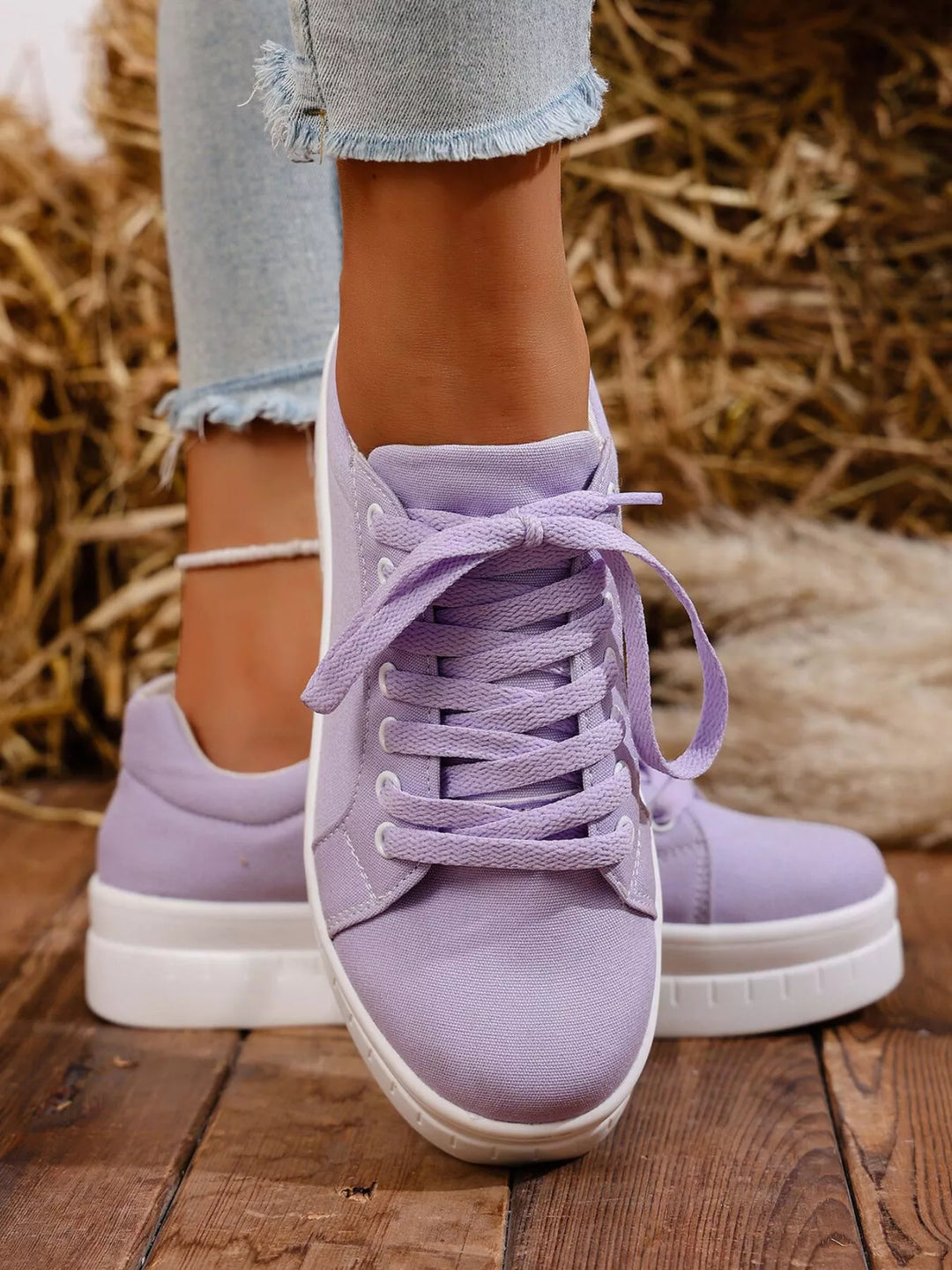Lilac low top lace up sneakers standing toe to toe, front view