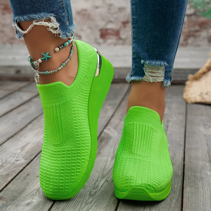 Lime green slip on knit platform sneakers, front view with ankle bracelets