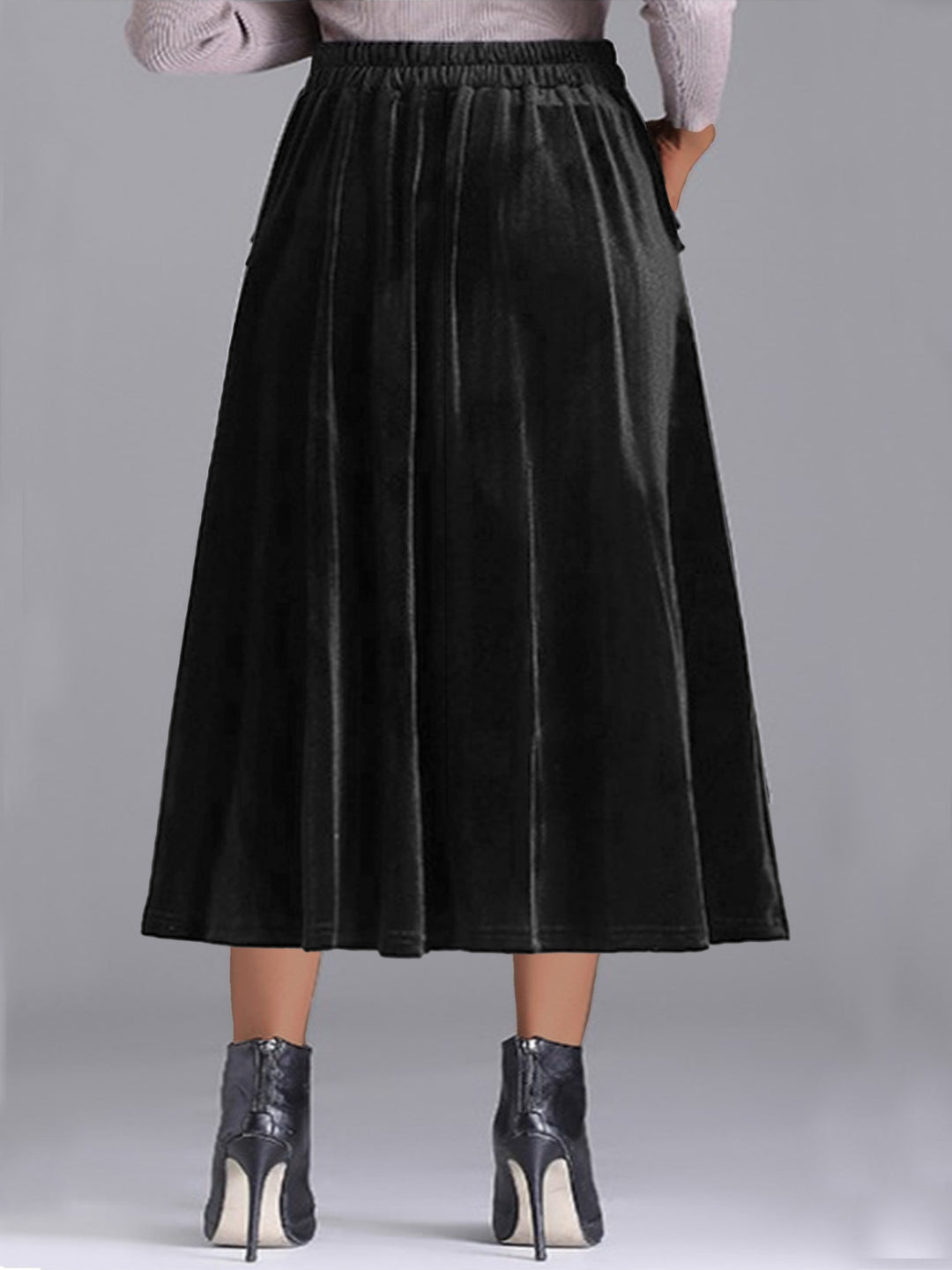Back view of the black pleated A line skirt with elastic waist