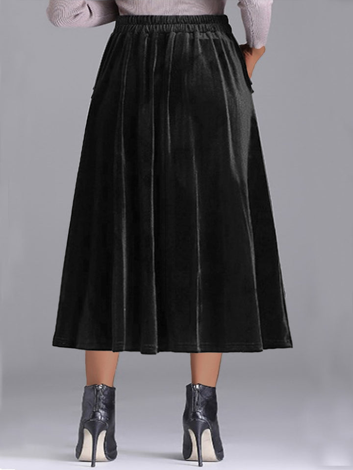Back view of the black pleated A line skirt with elastic waist