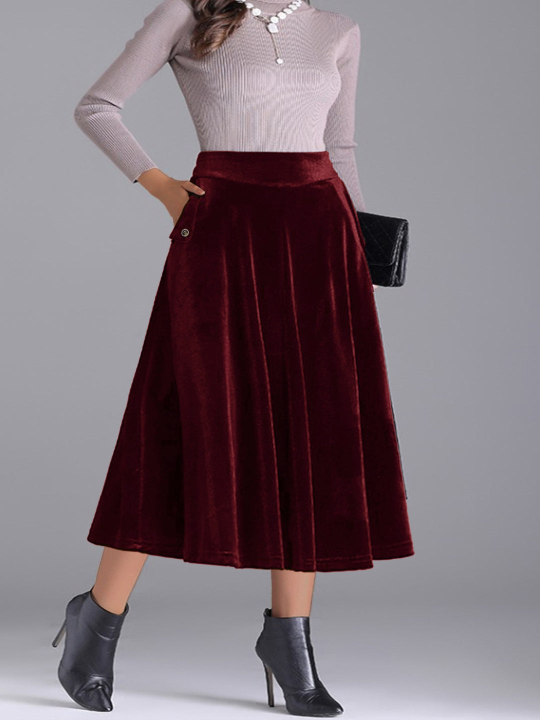 Burgundy high waist pleated skirt with a black clutch and gray sweater