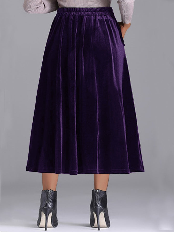 Back view of the deep purple pleated midi skirt with elastic waistband