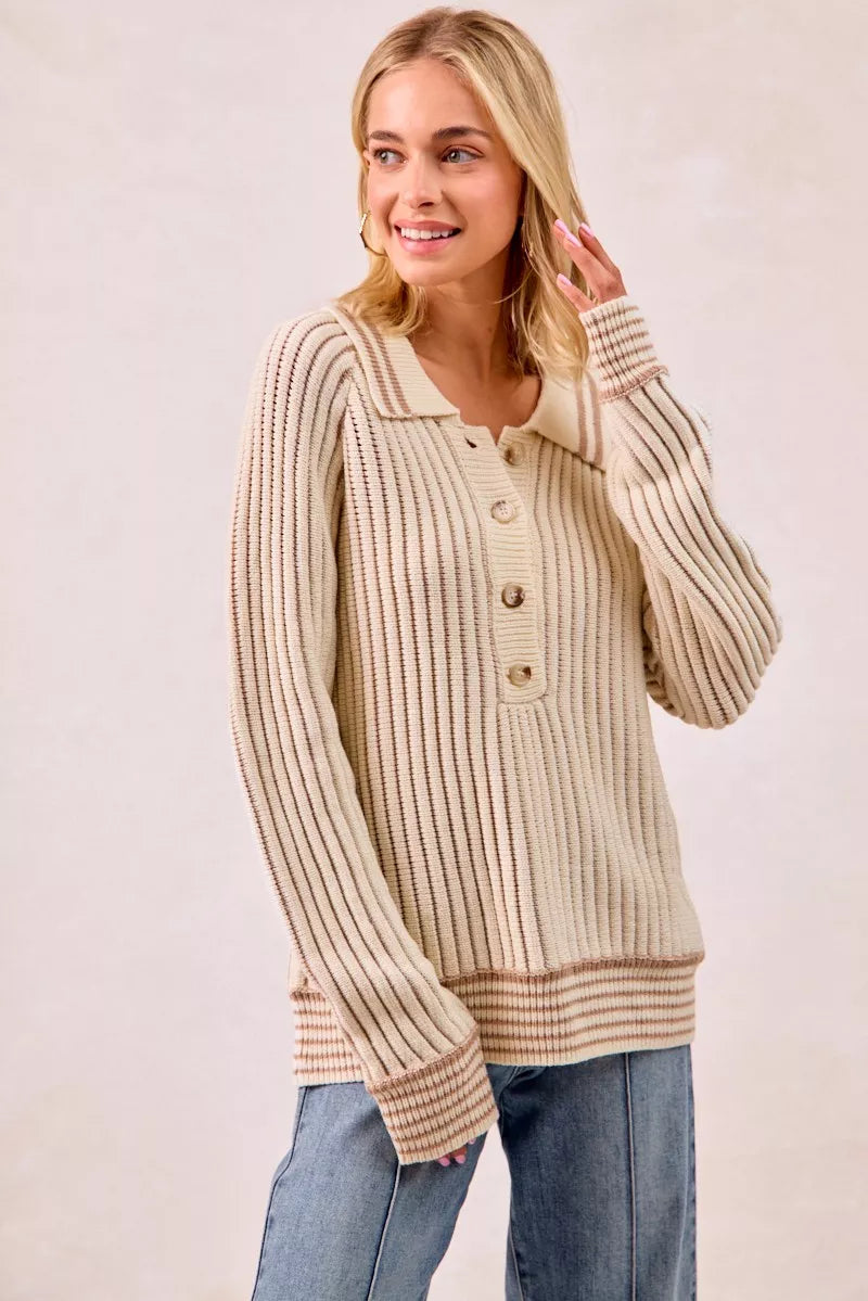 Cream ribbed polo sweater with hand near the collar and relaxed fit