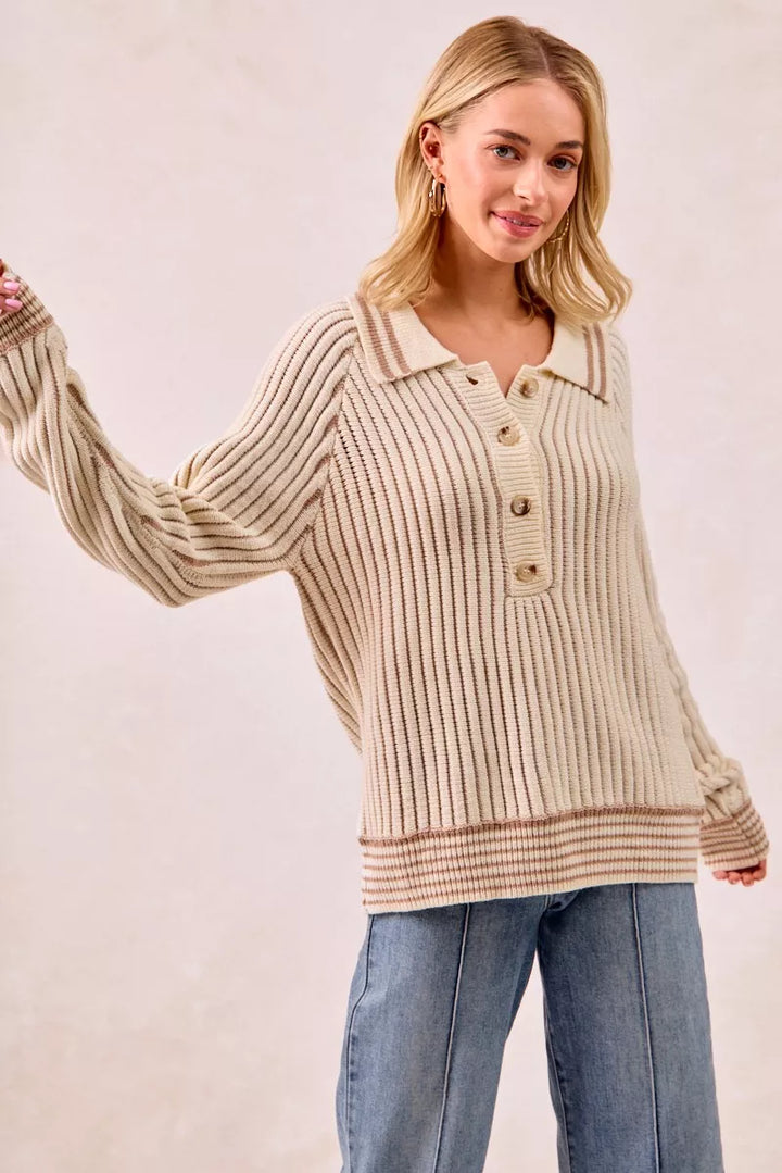 Cream ribbed polo sweater with one arm extended to the side