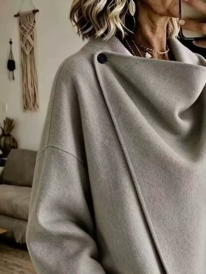Asymmetric cowl neck draped plus size in gray, close-up detail