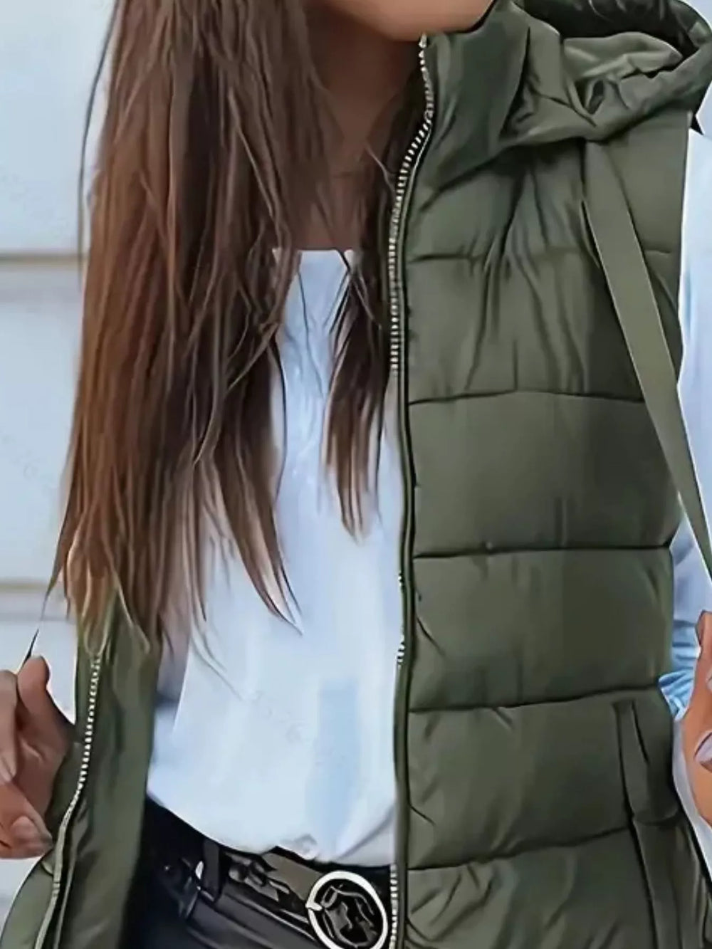 Close-up of the army green hooded quilted vest and zip front