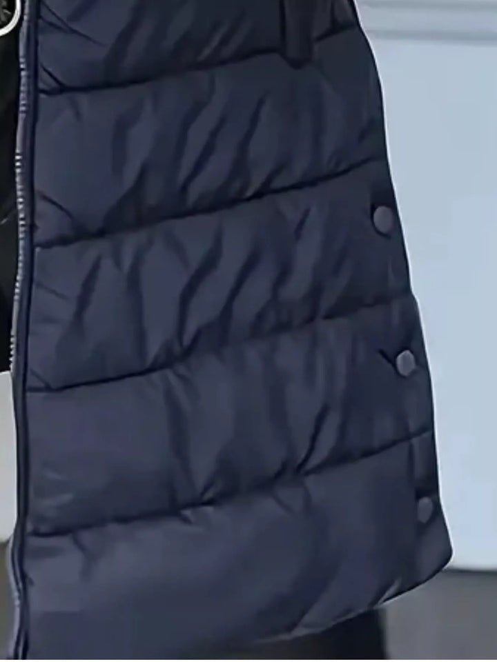 Close-up of the navy quilted vest with side snap buttons
