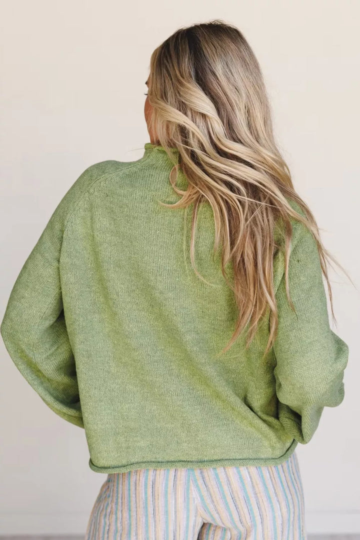 Pistachio green relaxed crew neck sweater seen from behind, loose fit