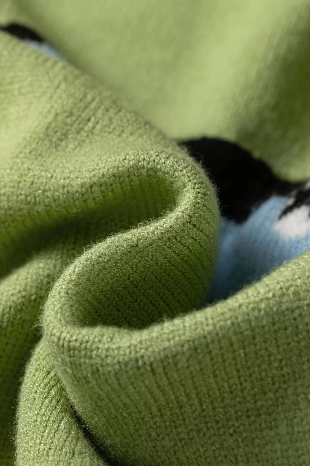 Detail of the rolled neckline with a glimpse of the blue fish graphic