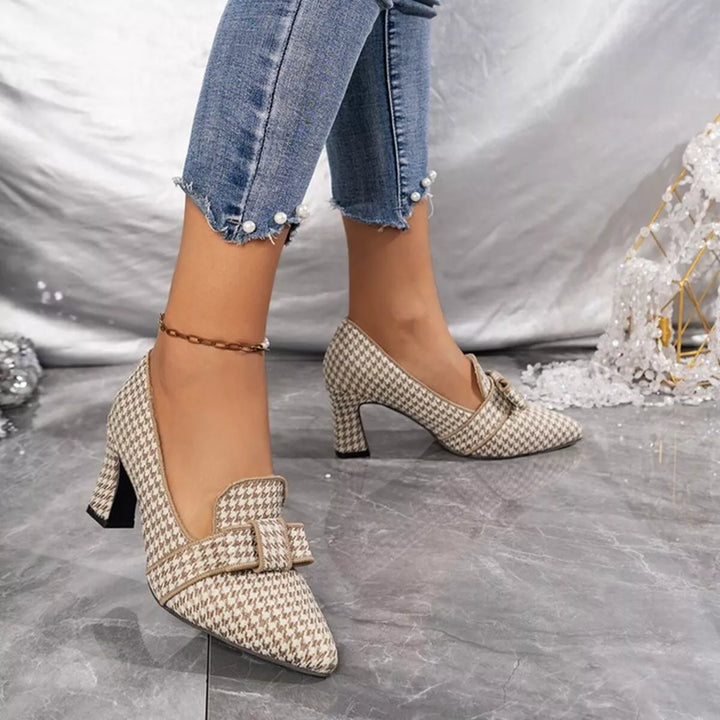 Beige houndstooth pump with bow detail and pointed toe, front angled view