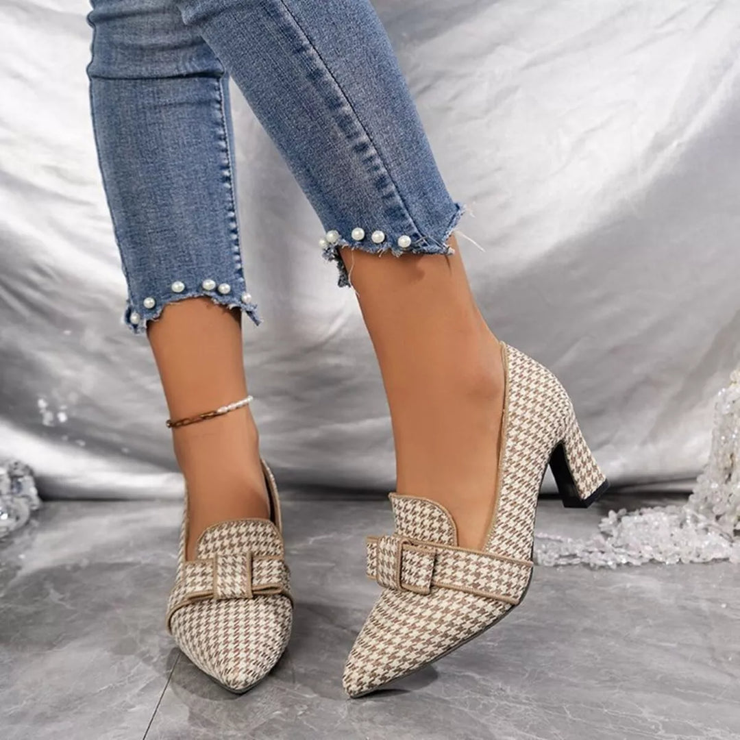 Beige houndstooth pointed toe pumps with block heels, worn with pearl hem jeans