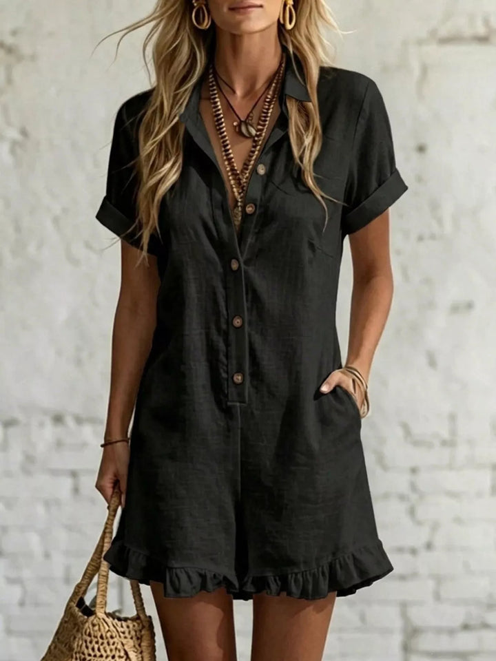 Black button front romper with short sleeves and a ruffled hem