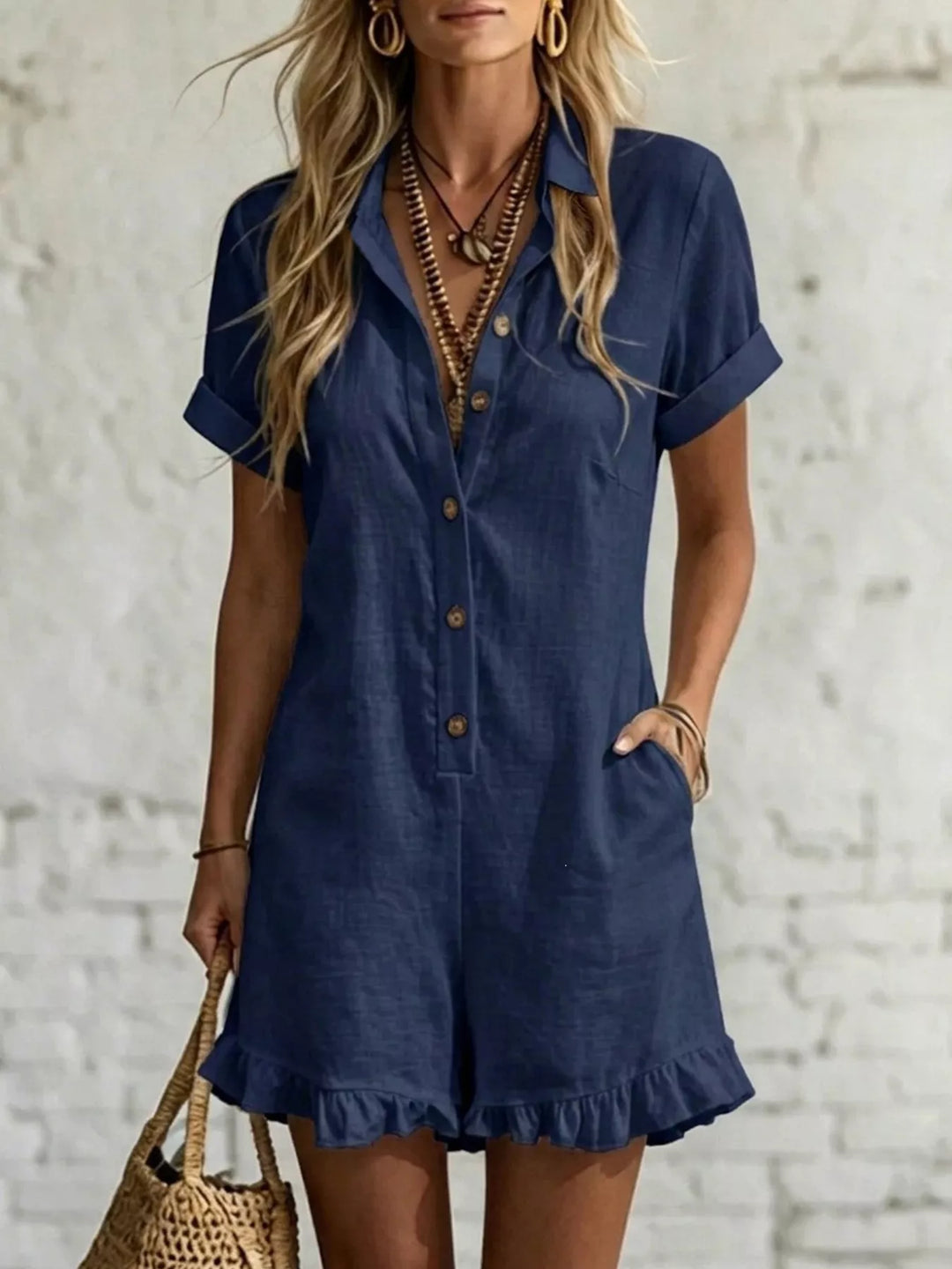 Women's romper in navy with short sleeves, button front and ruffle hem