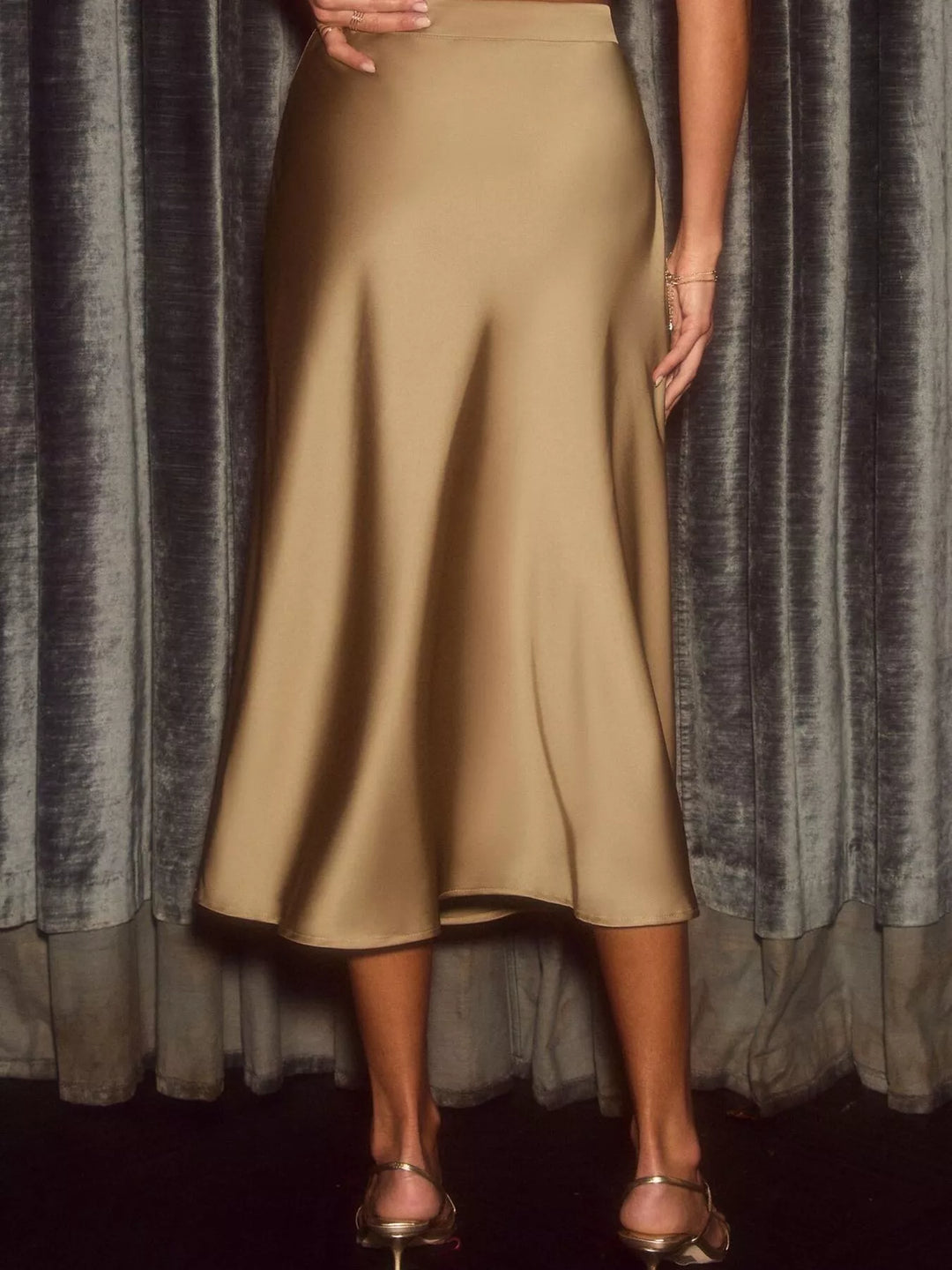 Gold high waisted midi skirt, full length view showing the flared hem