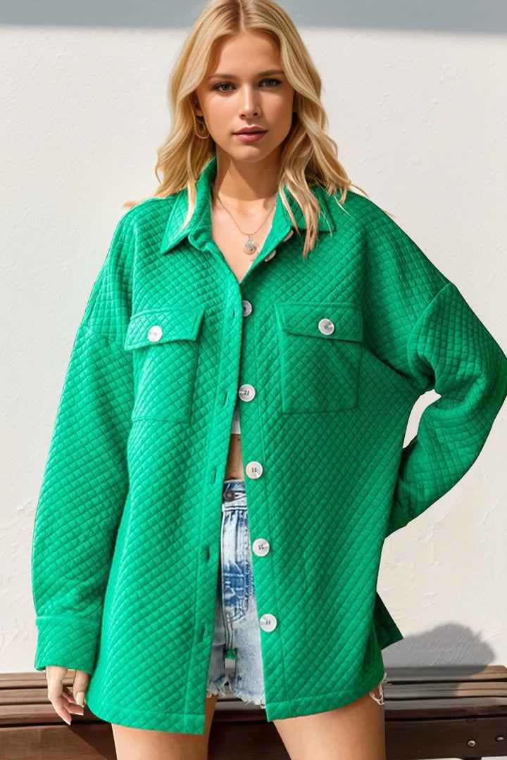 Women's shacket in emerald green with chest pockets and buttons, front view on model