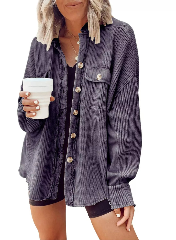 Charcoal waffle knit shacket with a flap pocket, front view holding a coffee cup
