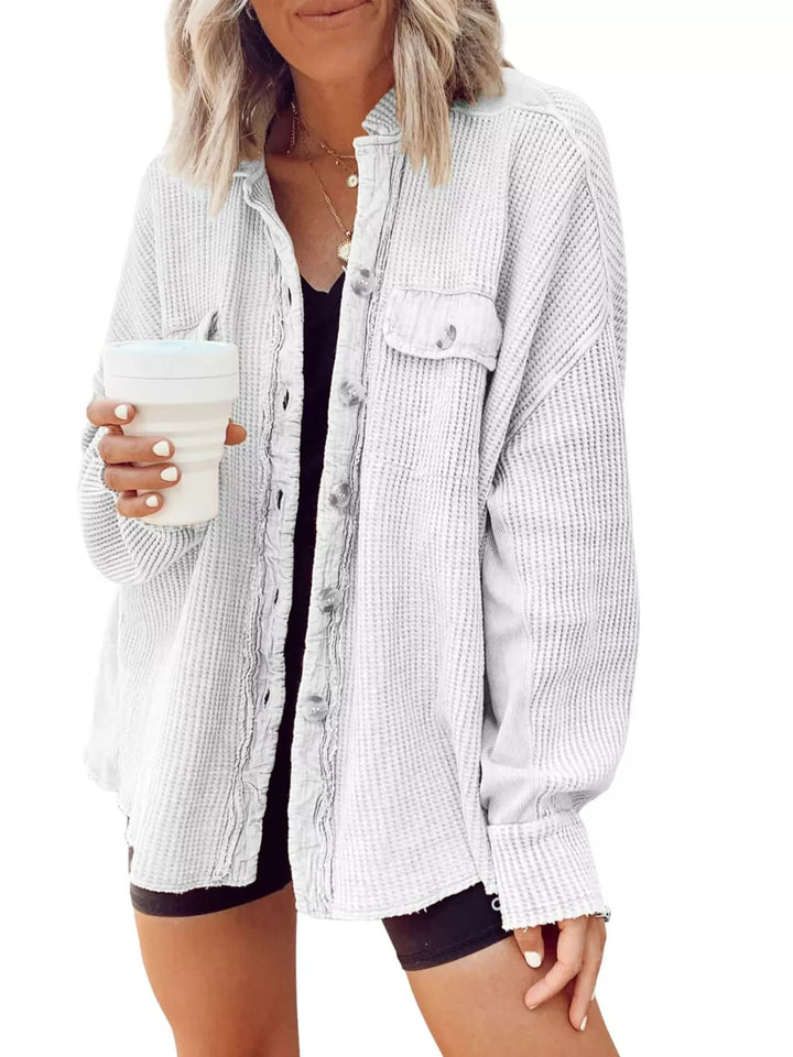 White oversized waffle knit shacket worn open with a black top