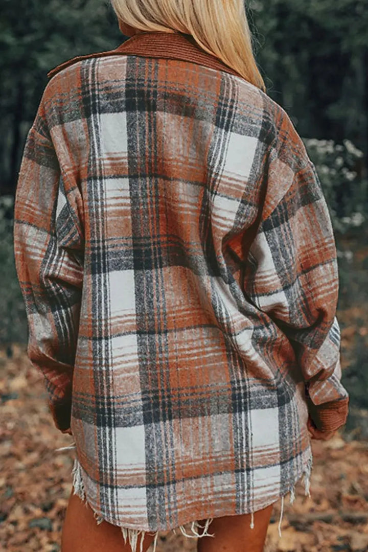 Back view of the rust plaid button up shacket worn outdoors