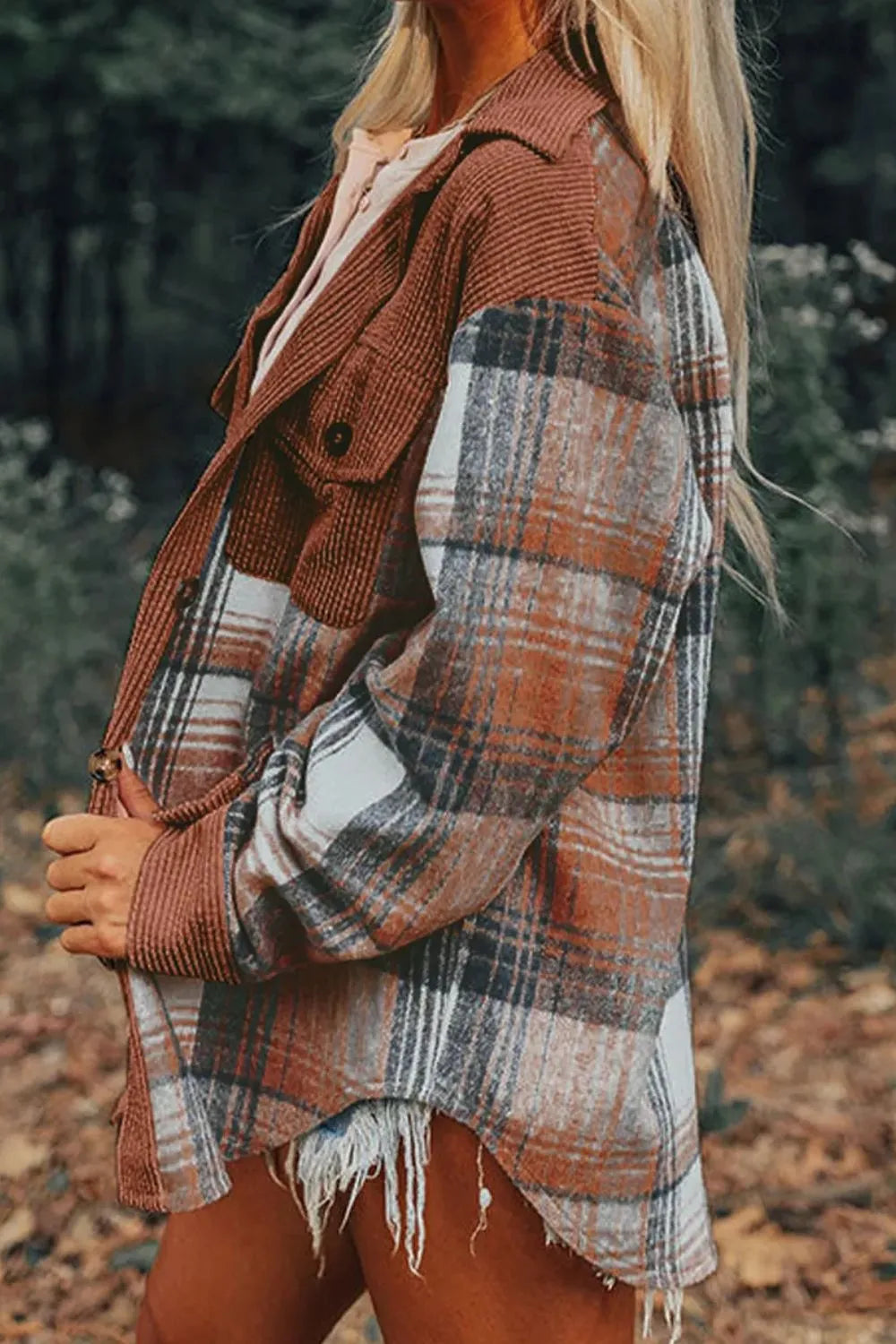 Side view of the rust plaid shacket with frayed hem and chest pocket