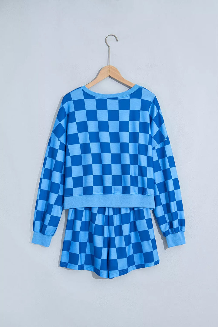 Blue checkerboard shorts set on a hanger, back view of the cropped top