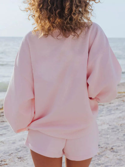 Back view of the blush pink oversized sweatshirt with matching shorts