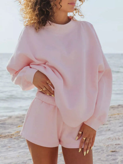 Women's blush pink shorts set, oversized fleece-look sweatshirt and shorts, on the beach