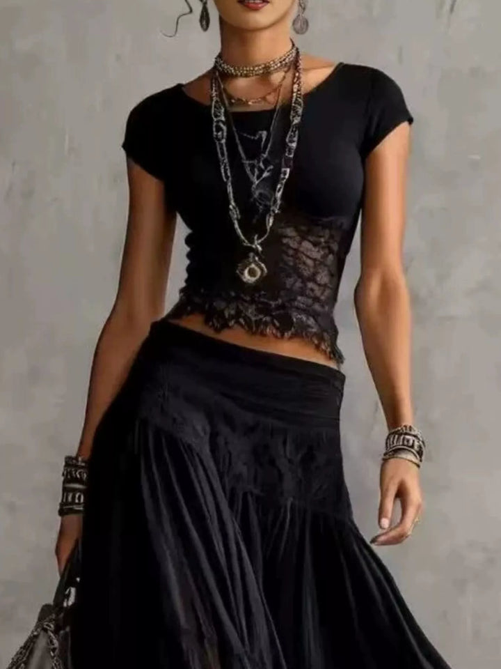 Black short sleeve top with lace detail and tiered maxi skirt, close-up