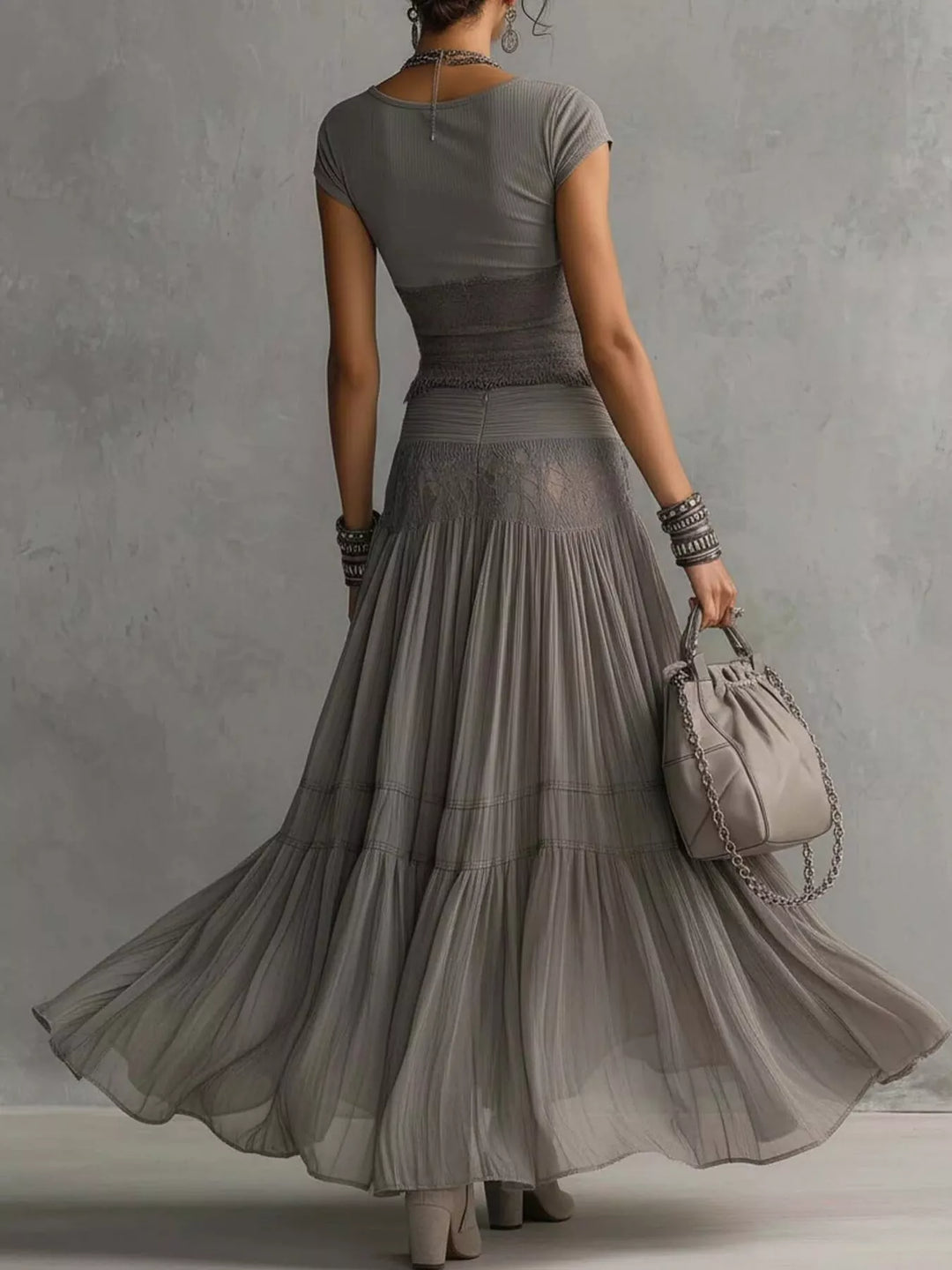 Back view of the gray short sleeve top and tiered flowing maxi skirt