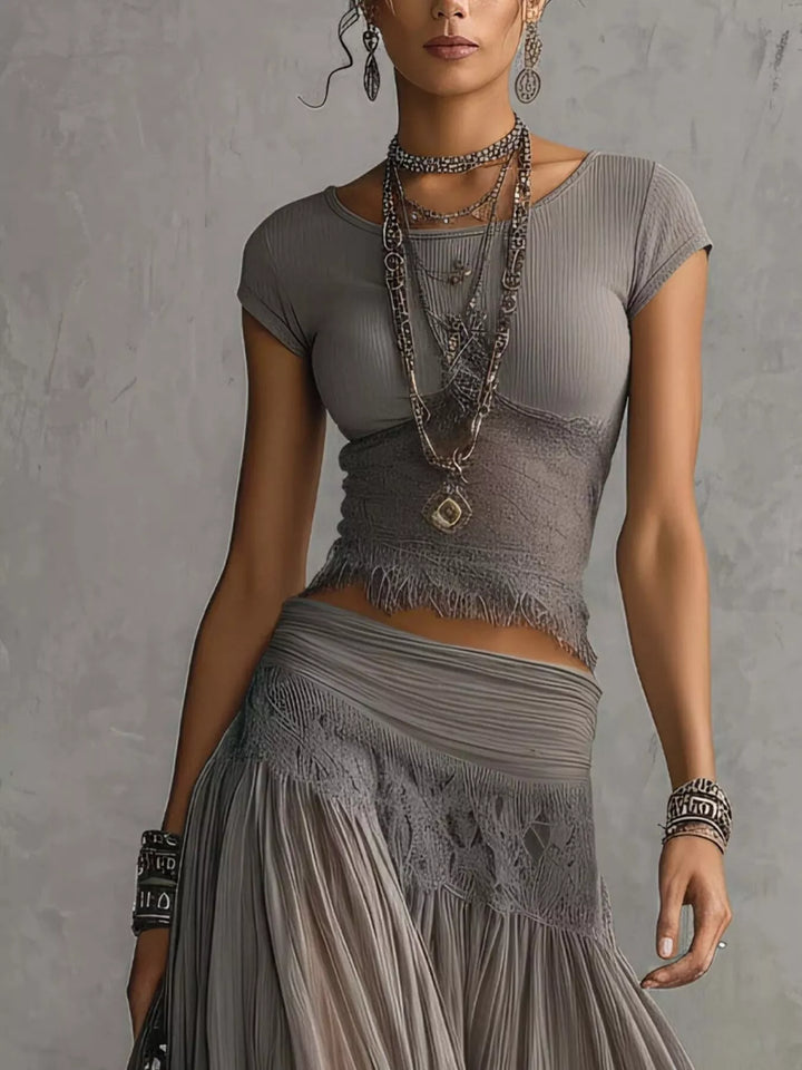 Gray lace trim top and tiered maxi skirt waist, torso close-up with layered necklaces